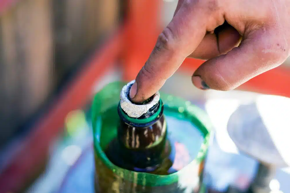 Homemade bong made from a plastic bottle being filled with cannabis ready for smoking